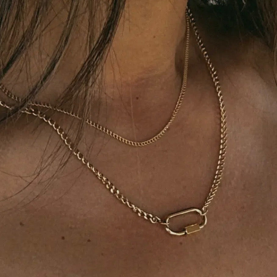 Close-up of a gold chain necklace on a person's neck